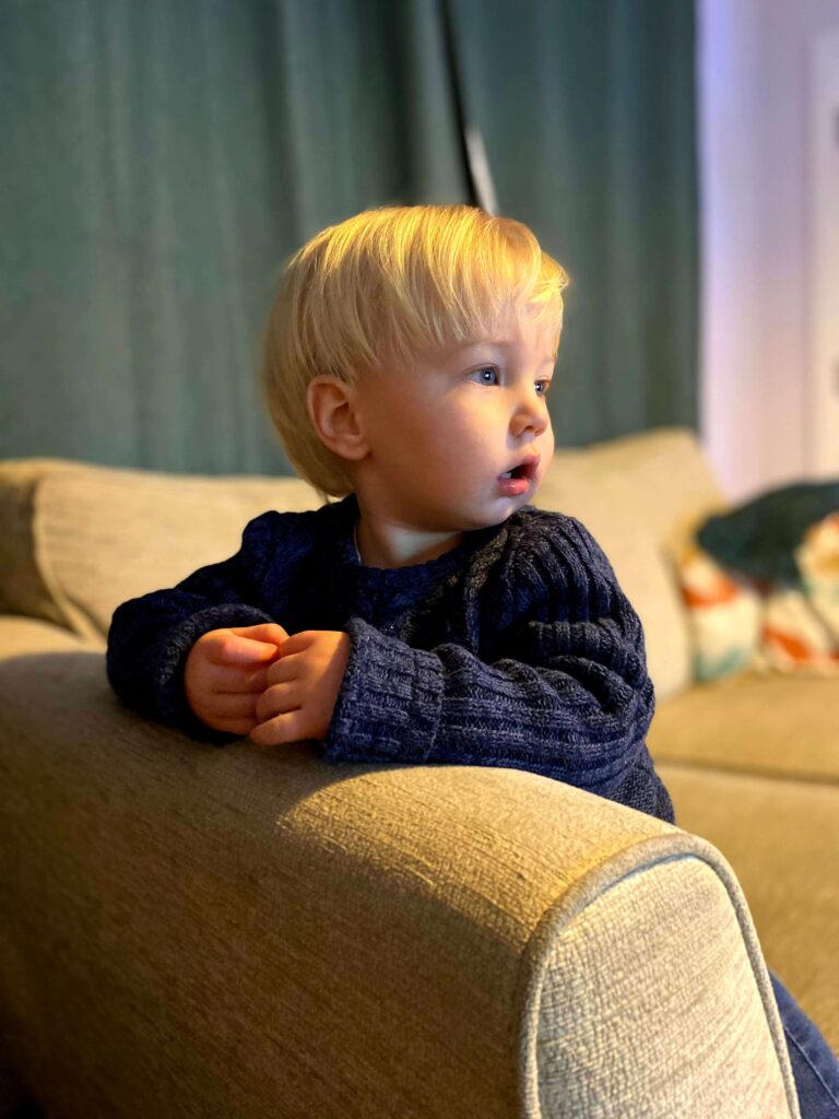 Boy called Noah watching TV on the settee