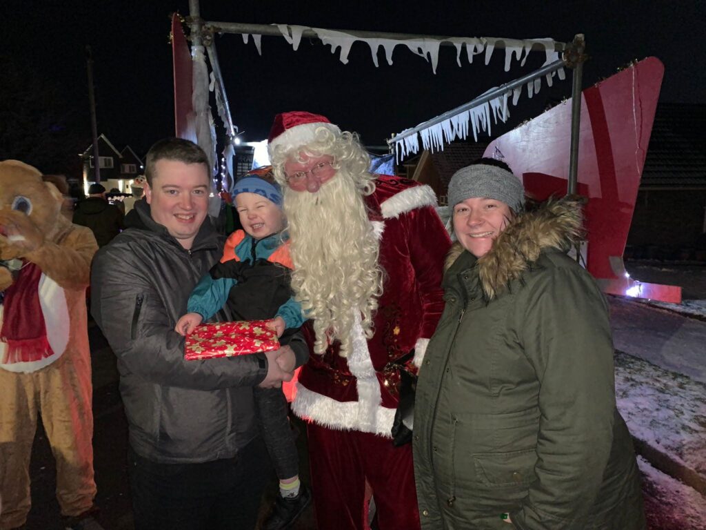 The Mulrooney family meeting Father Christmas who has come on a sleigh to local streets.